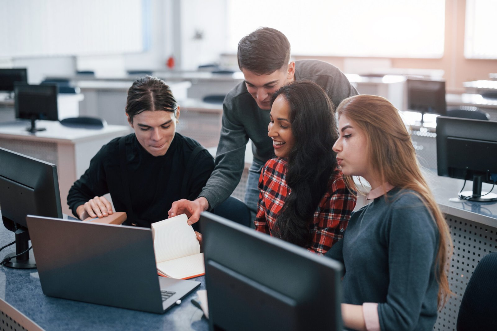 Group of young people in casual clothes working in the modern office.